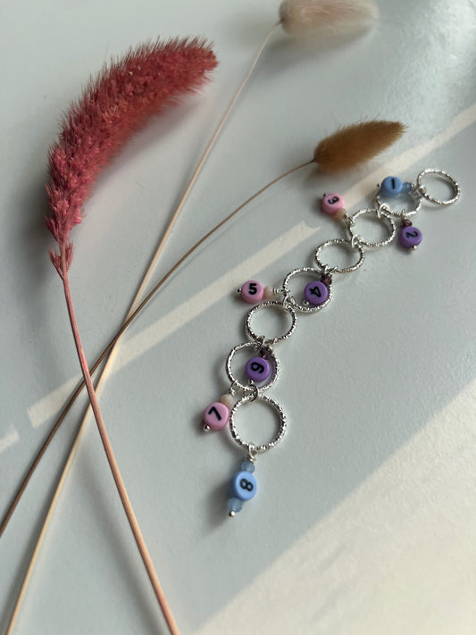 Knitted fish with number beads and purple, pink and blue details