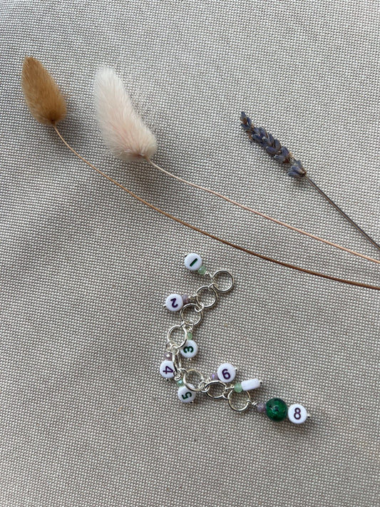 Knitted fish with number beads and purple and green details
