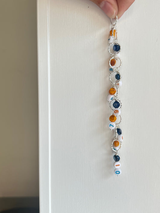 Knitted fish with number beads and deep blue and orange details