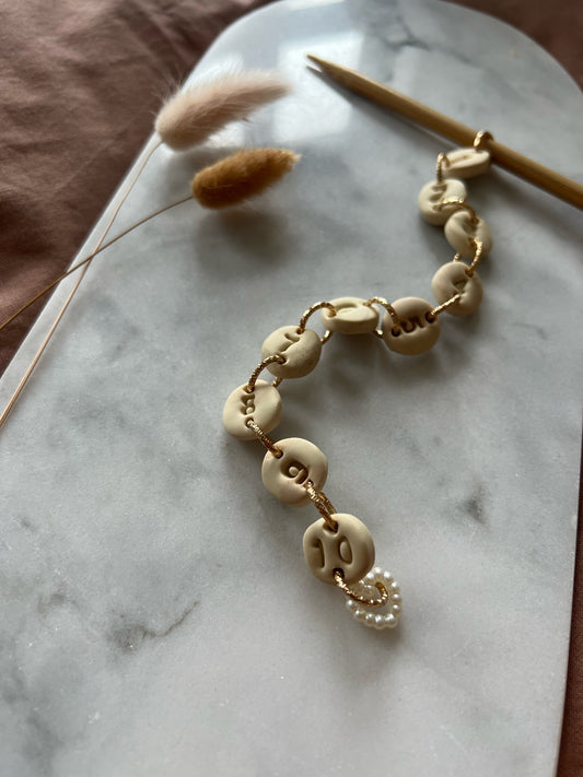 Knitting fish with handmade beige number beads and pearl heart pendant